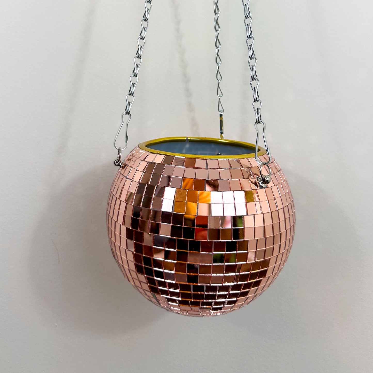 Close up of disco ball hanging planter in rose gold.