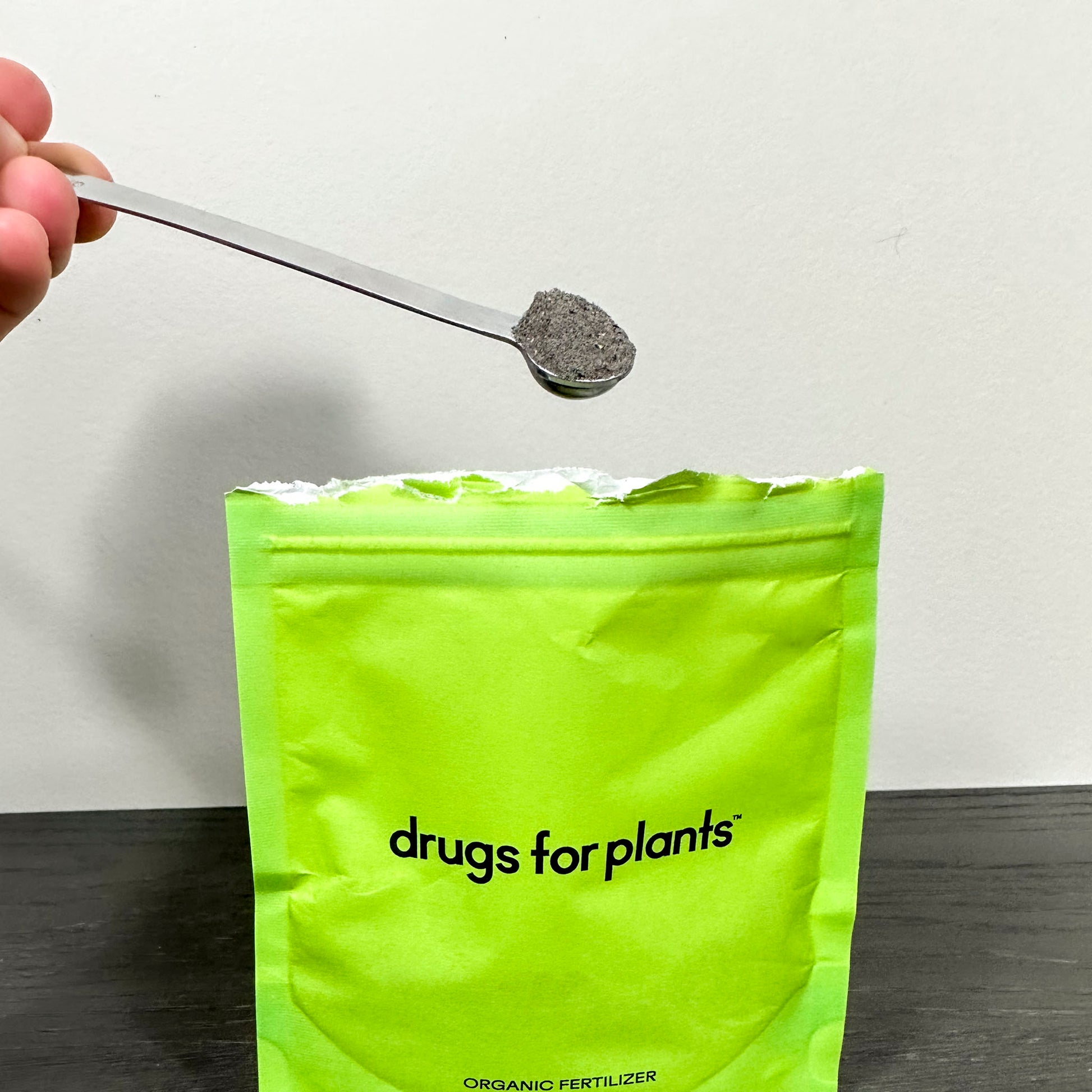 Drugs for plants silver measuring spoon holding fertilizer